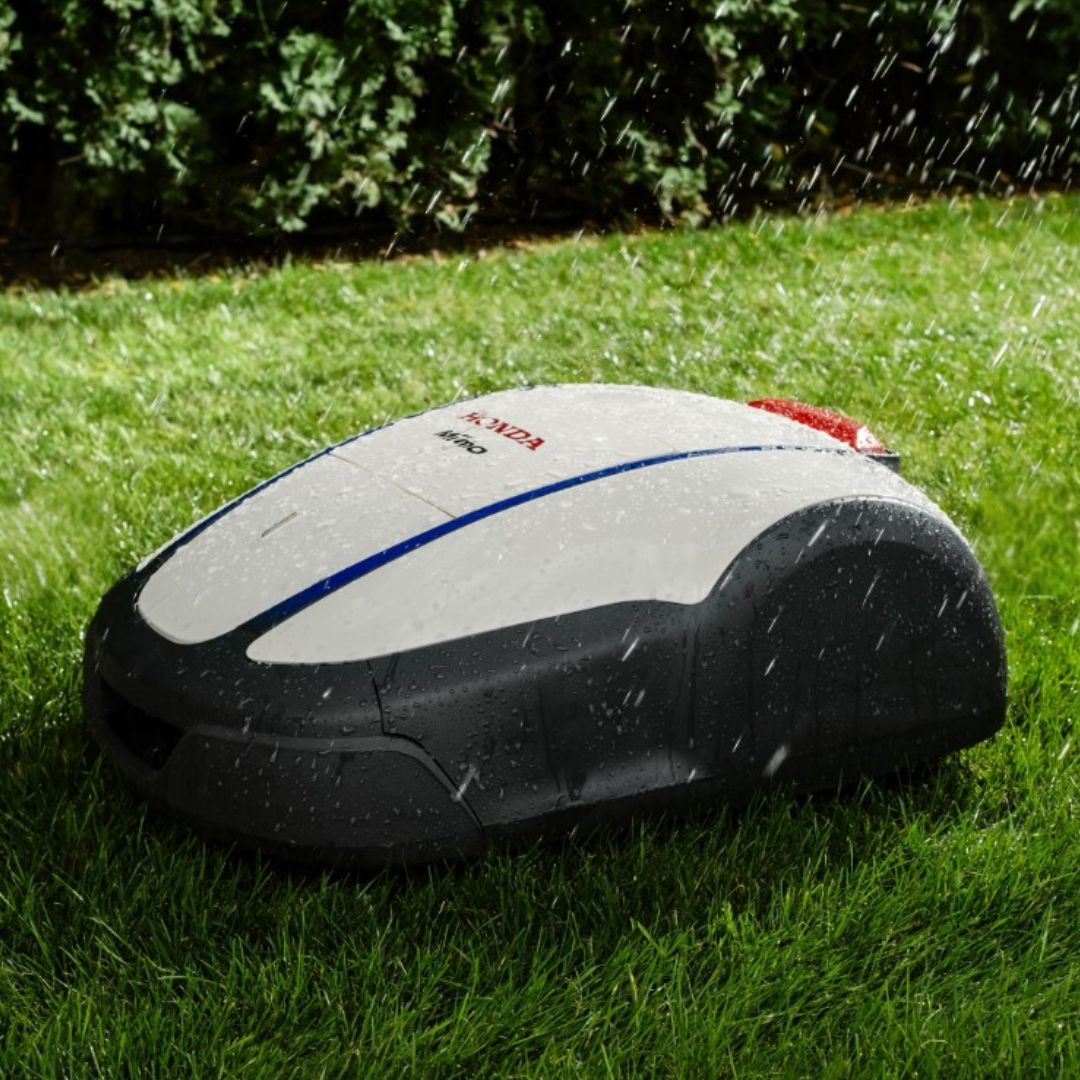 Honda Miimo HRM 1500 Live robotic lawn mower operating in wet weather, designed for reliable automatic lawn maintenance in changing conditions.