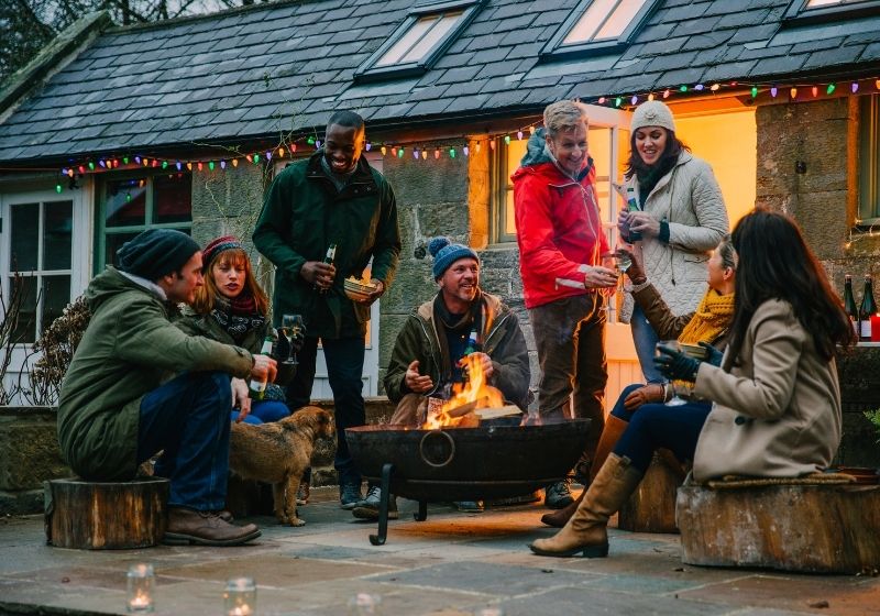 People gathered around firepit in garden